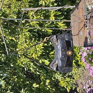 Coach beautiful black, stiff leather, brass hardware handbag.